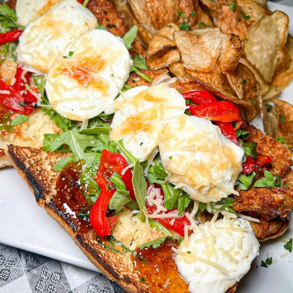 Toasted bread topped with fresh mozzarella, red peppers, arugula, and crispy potato chips.